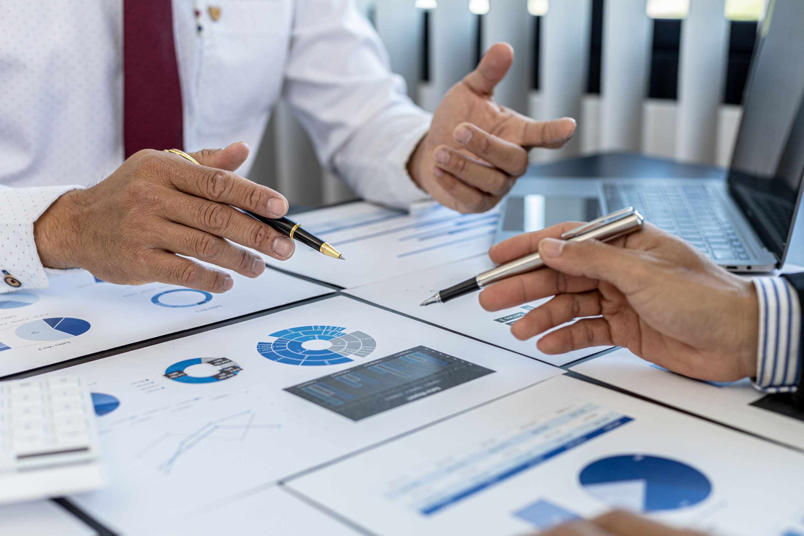 close-up-sales-manager-pressing-white-calculator-he-is-examining-sales-figures-with-management-summarize-monthly-results-joint-planning-sales-management-concept (1) (1)