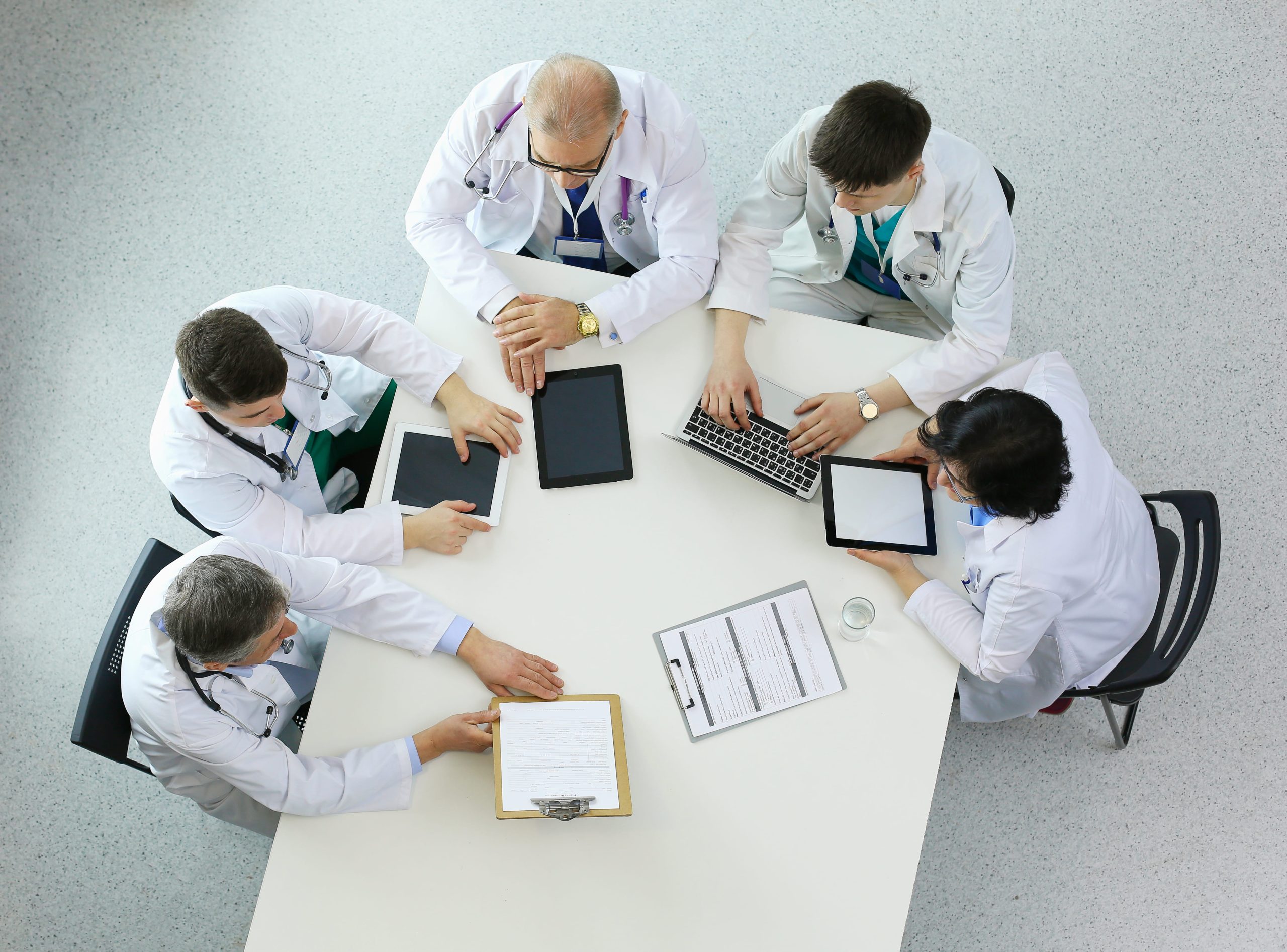 medical-team-sitting-discussing-table-top-view (2) (1)