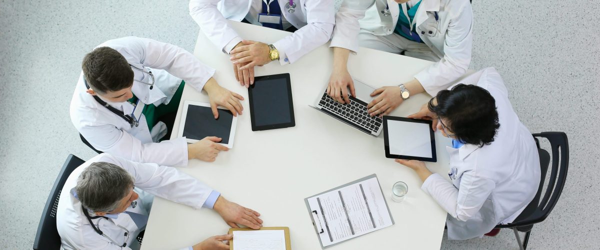 medical-team-sitting-discussing-table-top-view (2) (1)